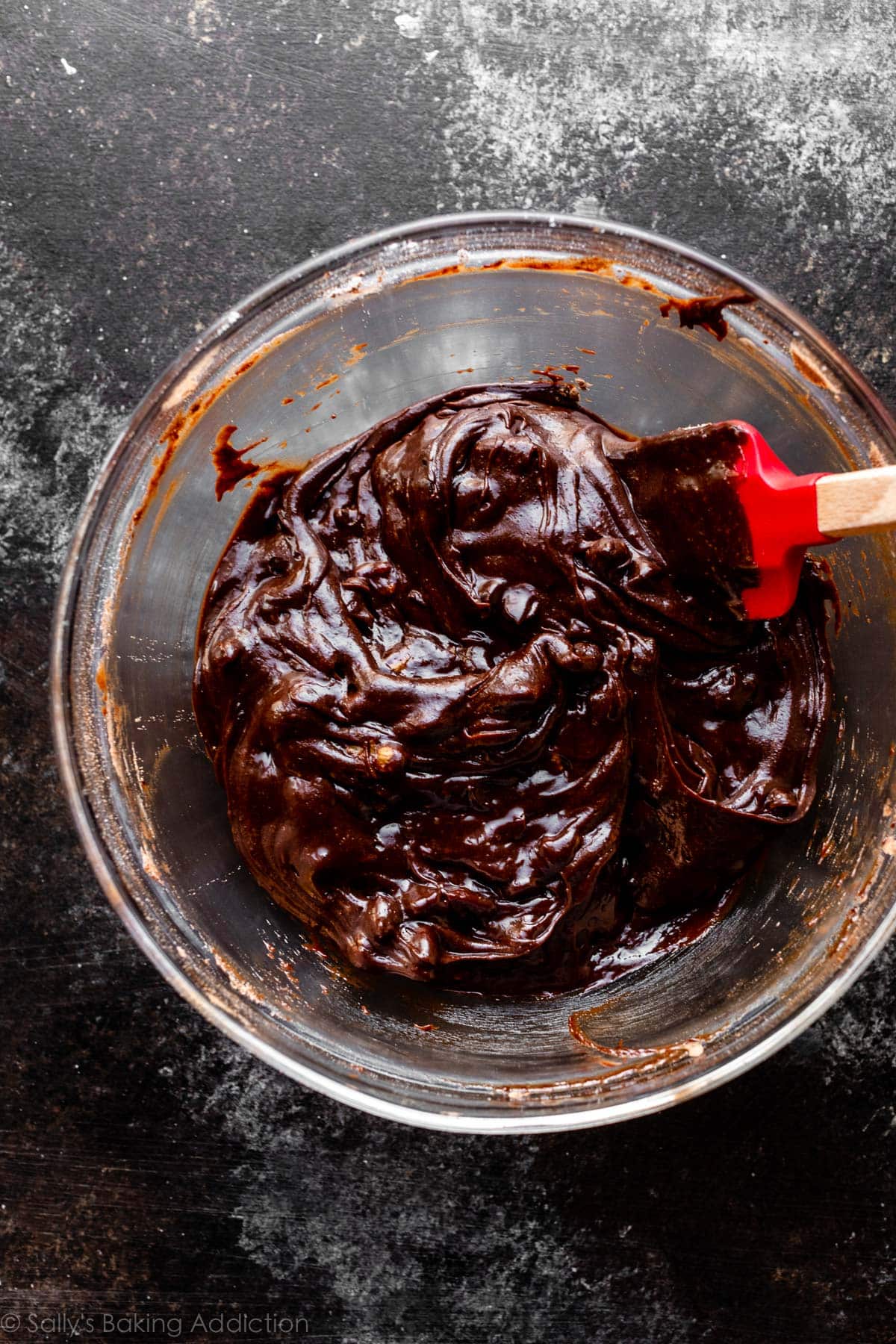 brownie batter with walnuts and chocolate chips pictured in glass bowl