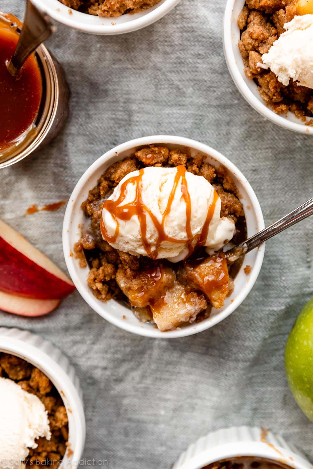 apple crumble in ramekin with ice cream and caramel on top