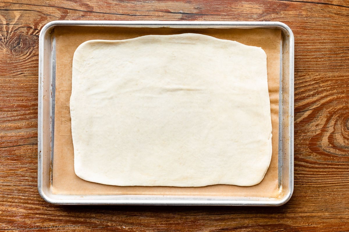 rough puff pastry dough rolled out on baking sheet