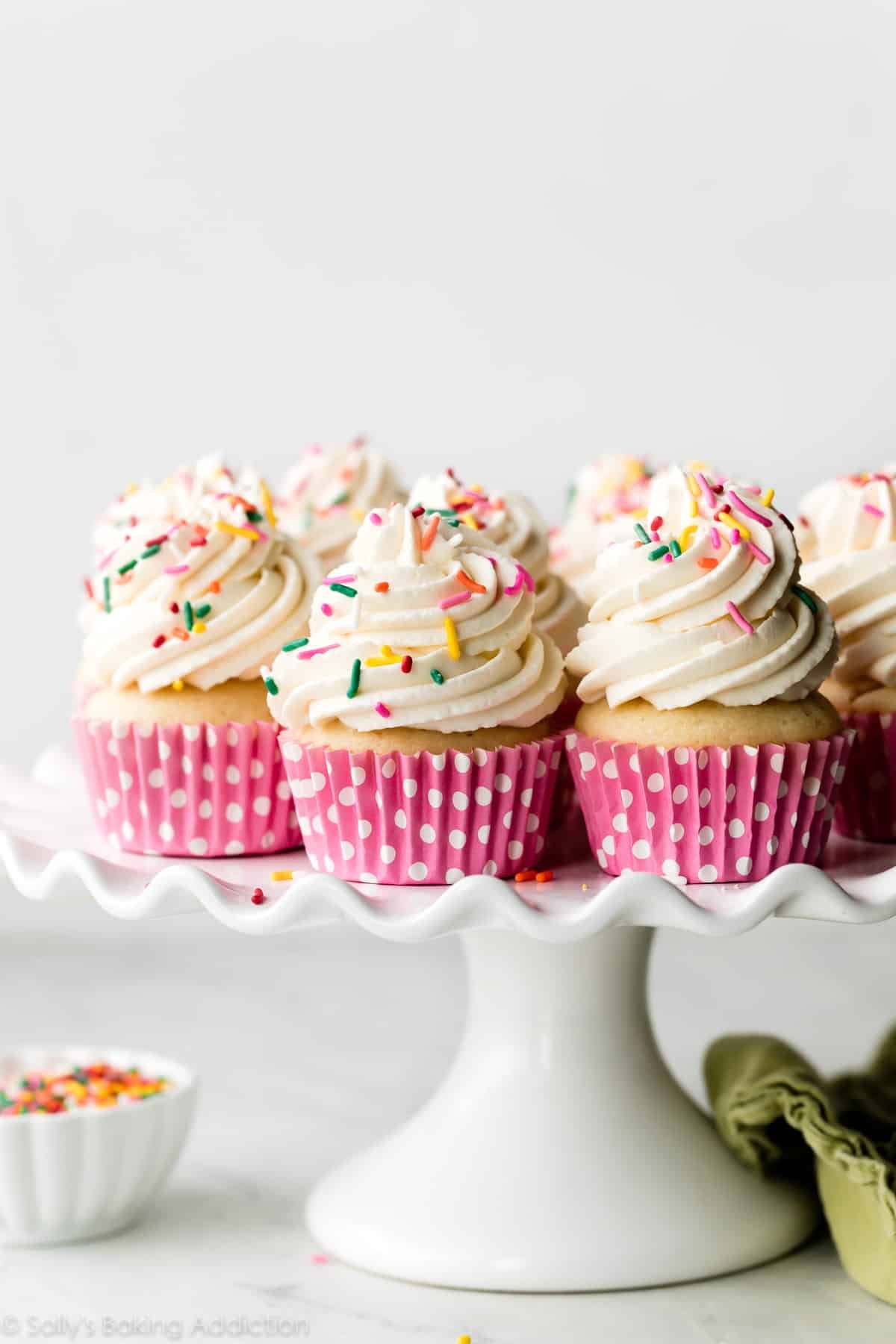 whipped frosting piped on vanilla cupcakes