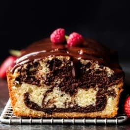 marble loaf cake with ganache and raspberries on top