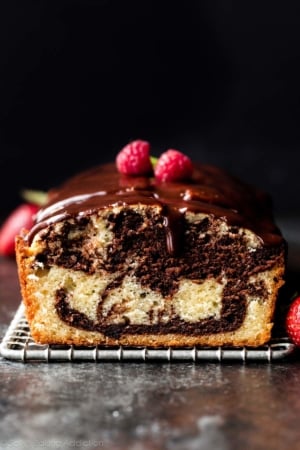 marble loaf cake with ganache and raspberries on top