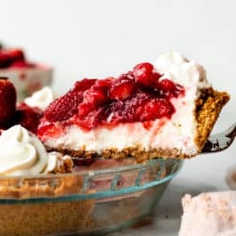 removing slice of strawberry cream cheese pie from pie dish