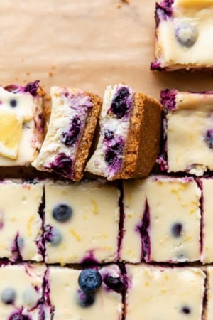 lemon blueberry cheesecake bars with graham cracker crust.