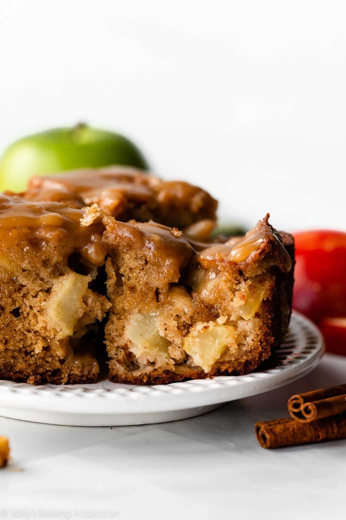 apple cake slice with lots of fresh apples inside and topped with brown sugar glaze.