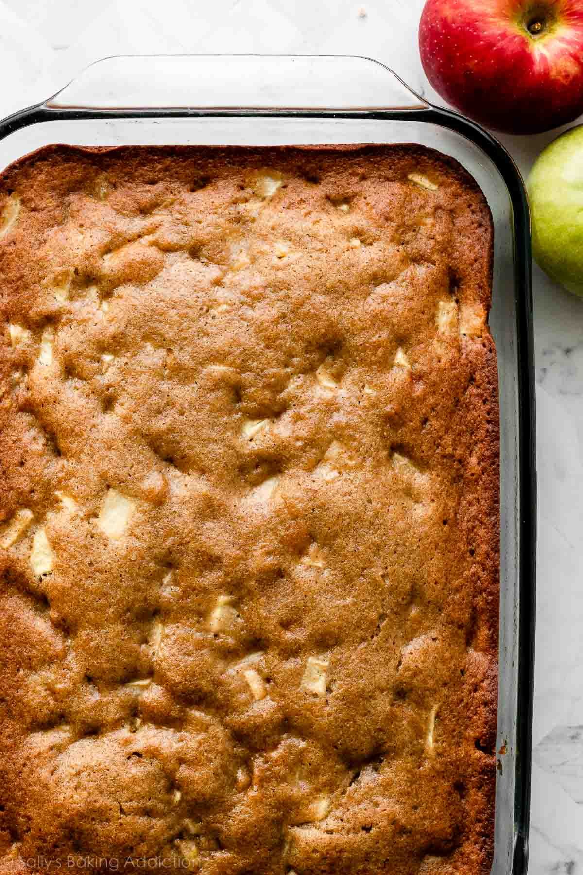 plain apple cake in glass baking dish.