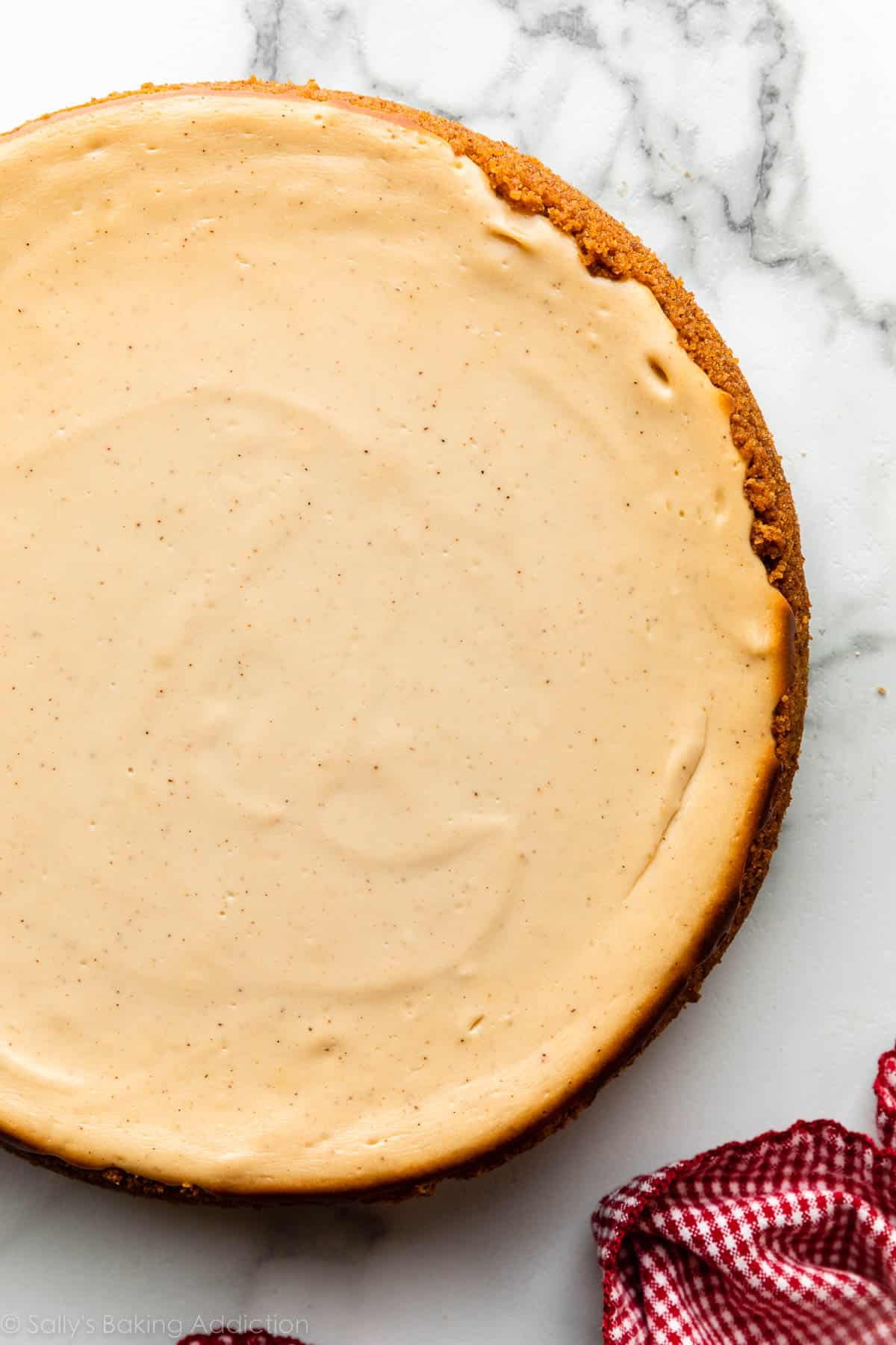 brown sugar cheesecake outside of springform pan on marble counter.