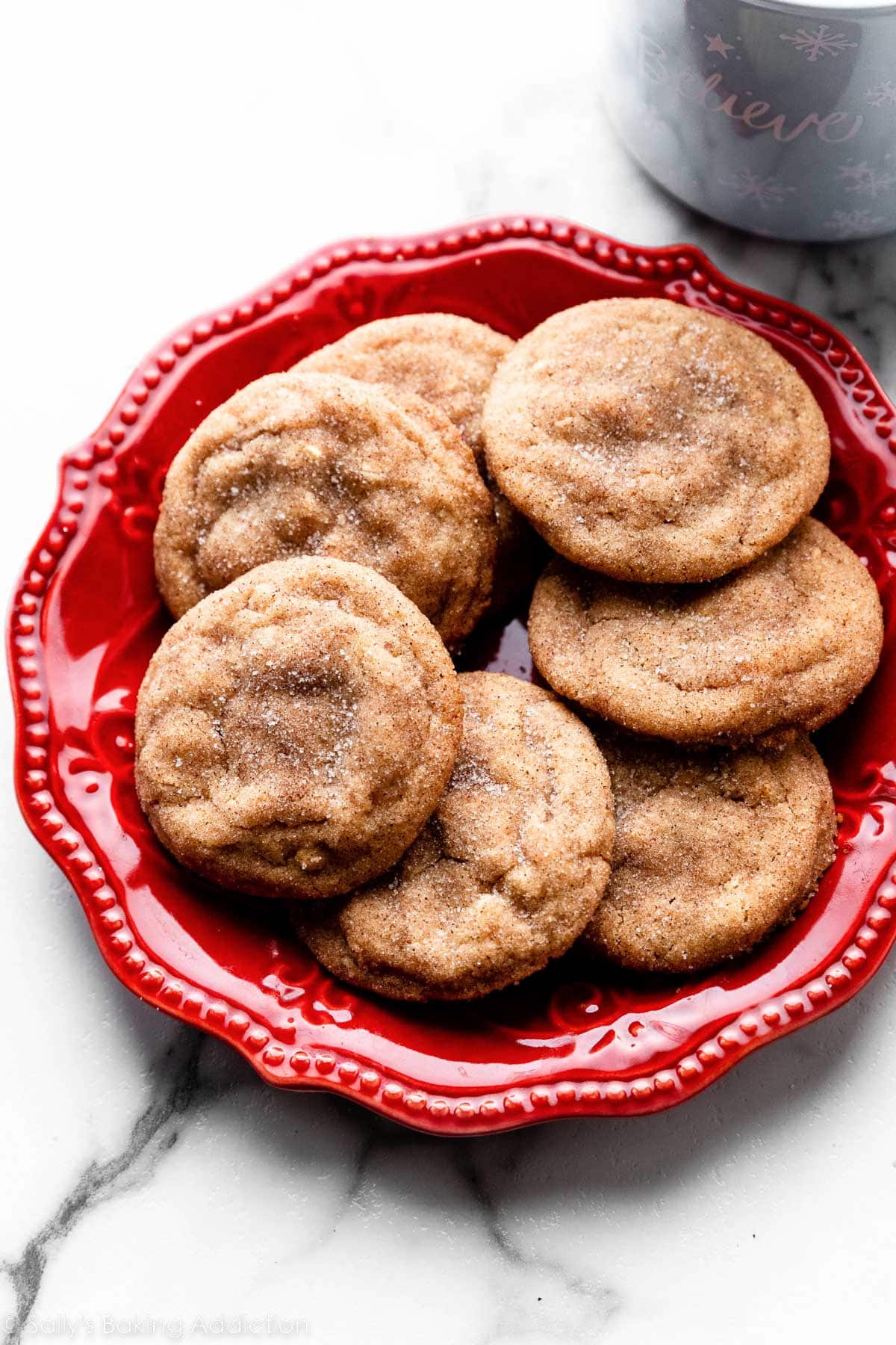 peanut butter snickerdoodles arranged on red plate.