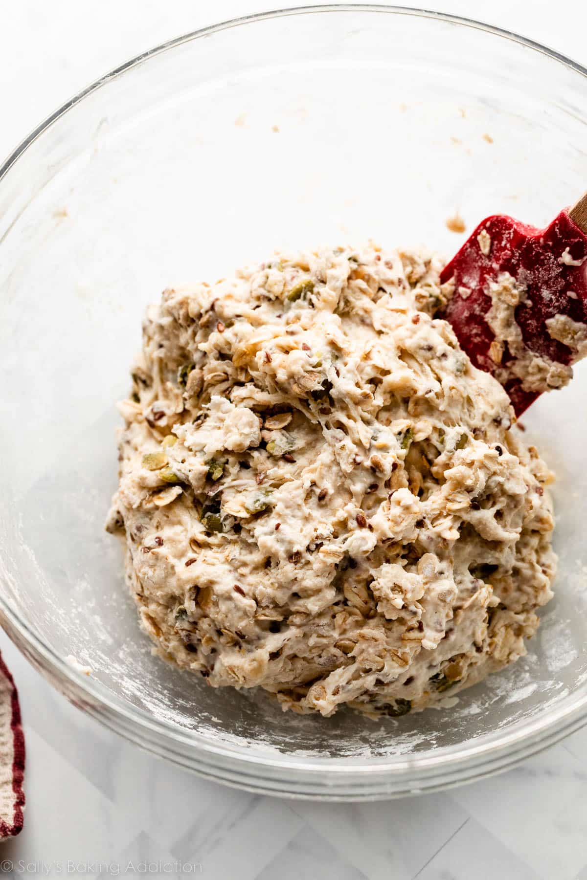 dough with seeds in it in glass bowl.