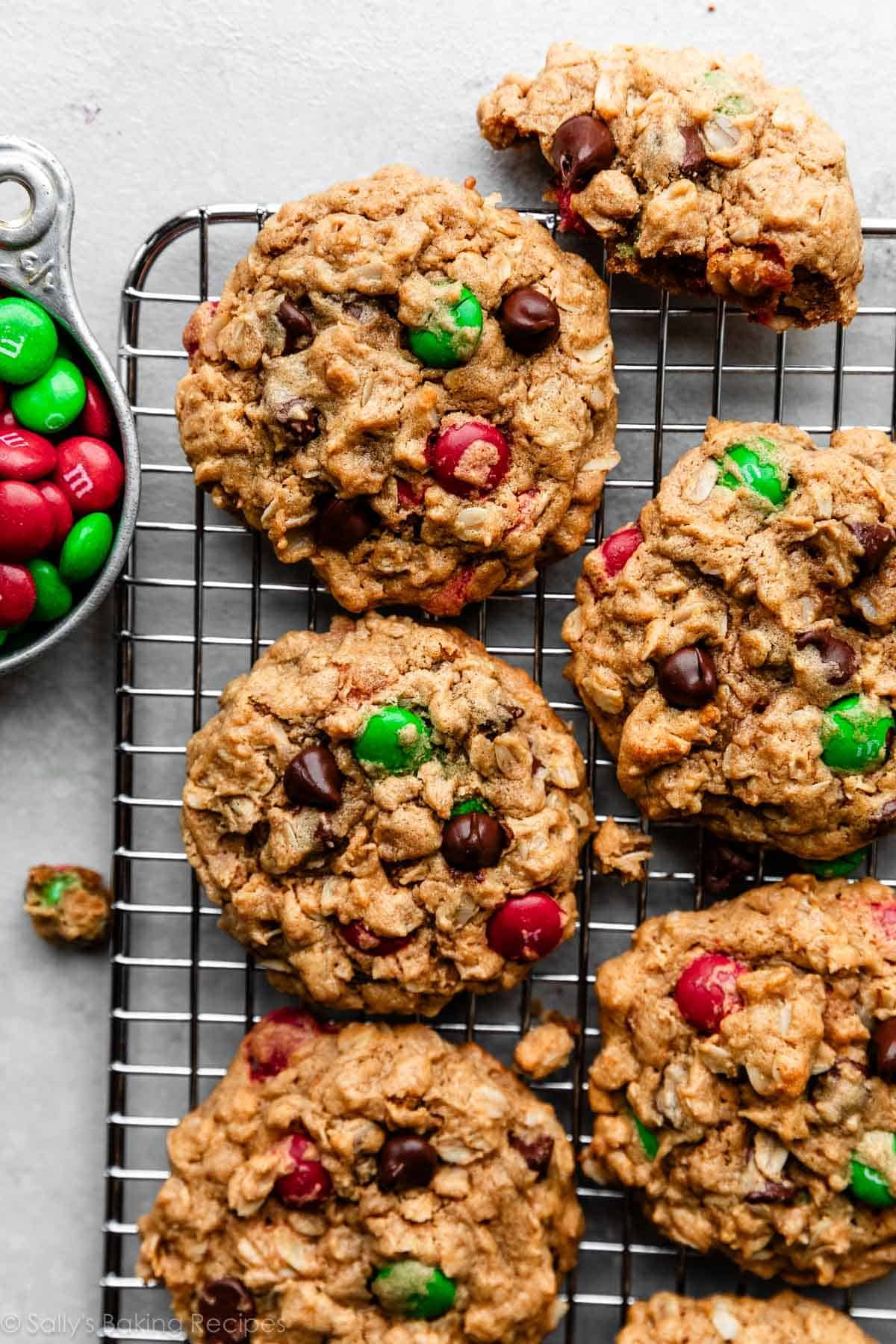 monster Christmas-colored M&M peanut butter oatmeal cookies on wire cooling rack.