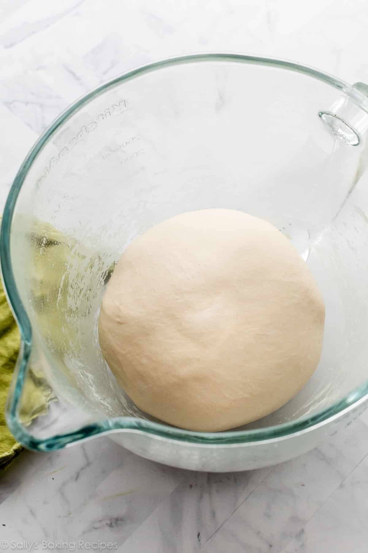 dough in glass stand mixer bowl.