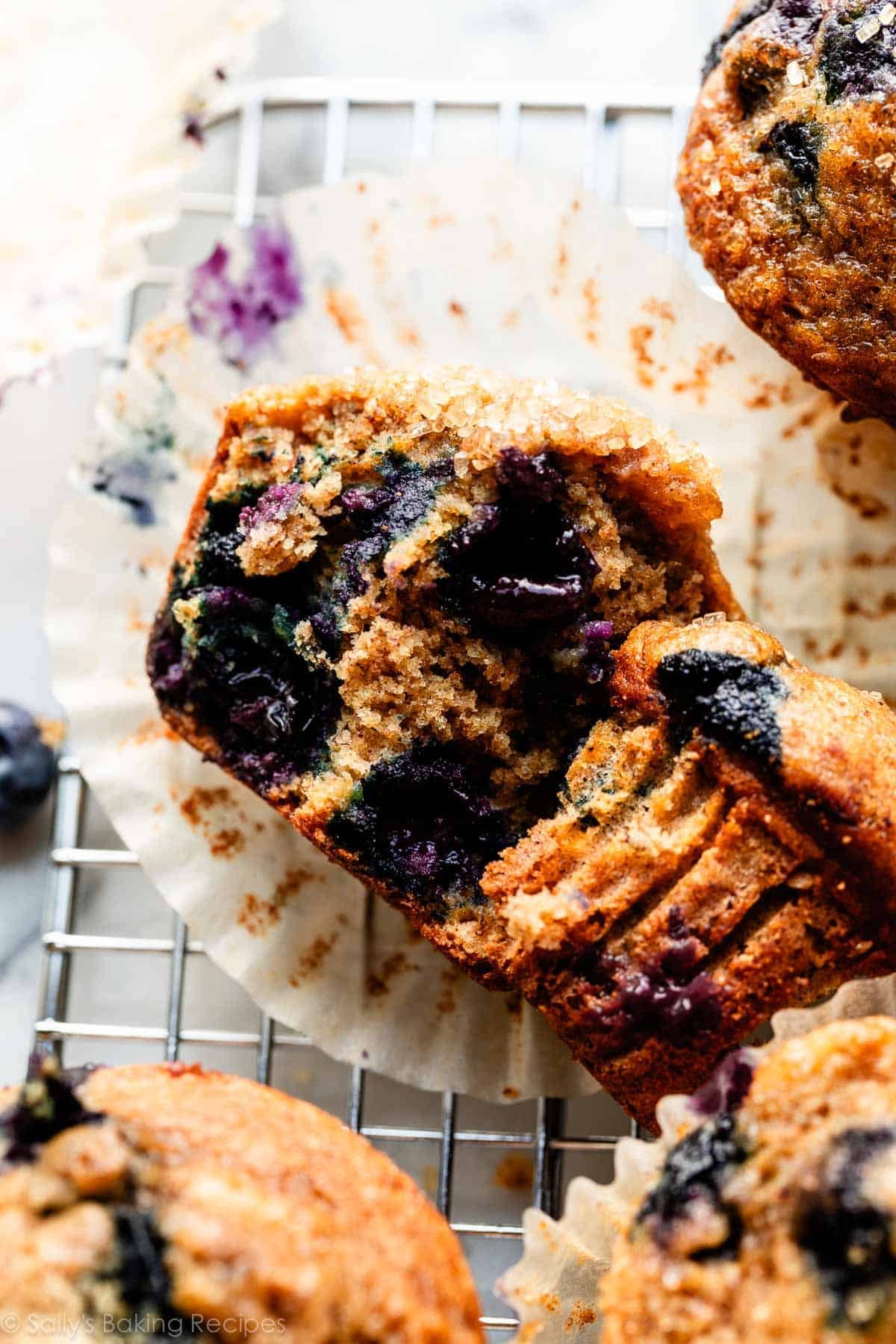 blueberry banana muffin cut open on cooling rack.