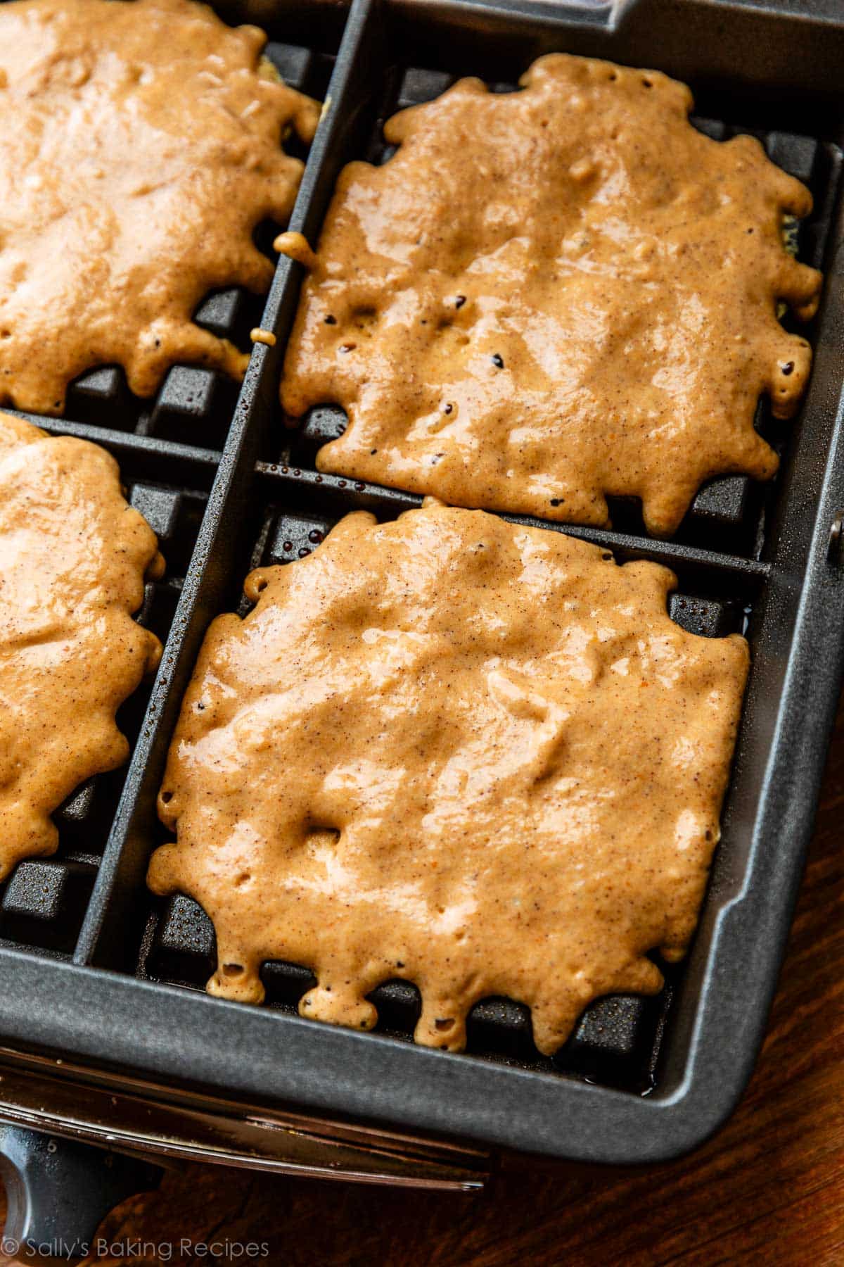 pumpkin batter poured into waffle maker machine.