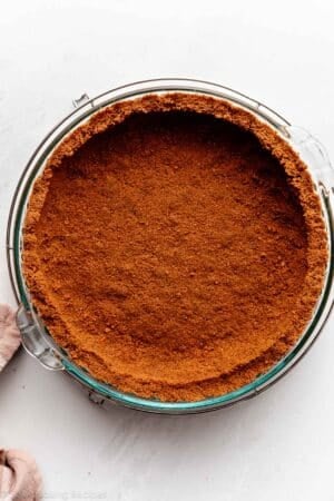 pressed Biscoff pie crust in glass pie dish.