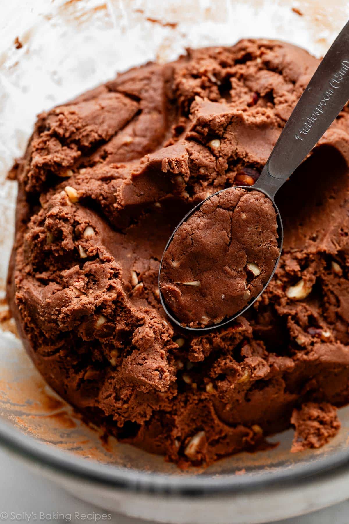 cookie dough in bowl with Tablespoon measuring spoon.