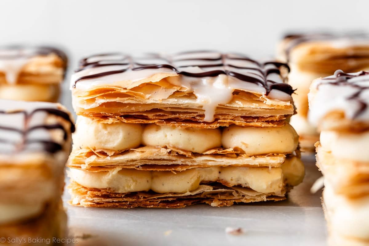 slices on napoleon pastry dessert with icing on top and dripping down the side.