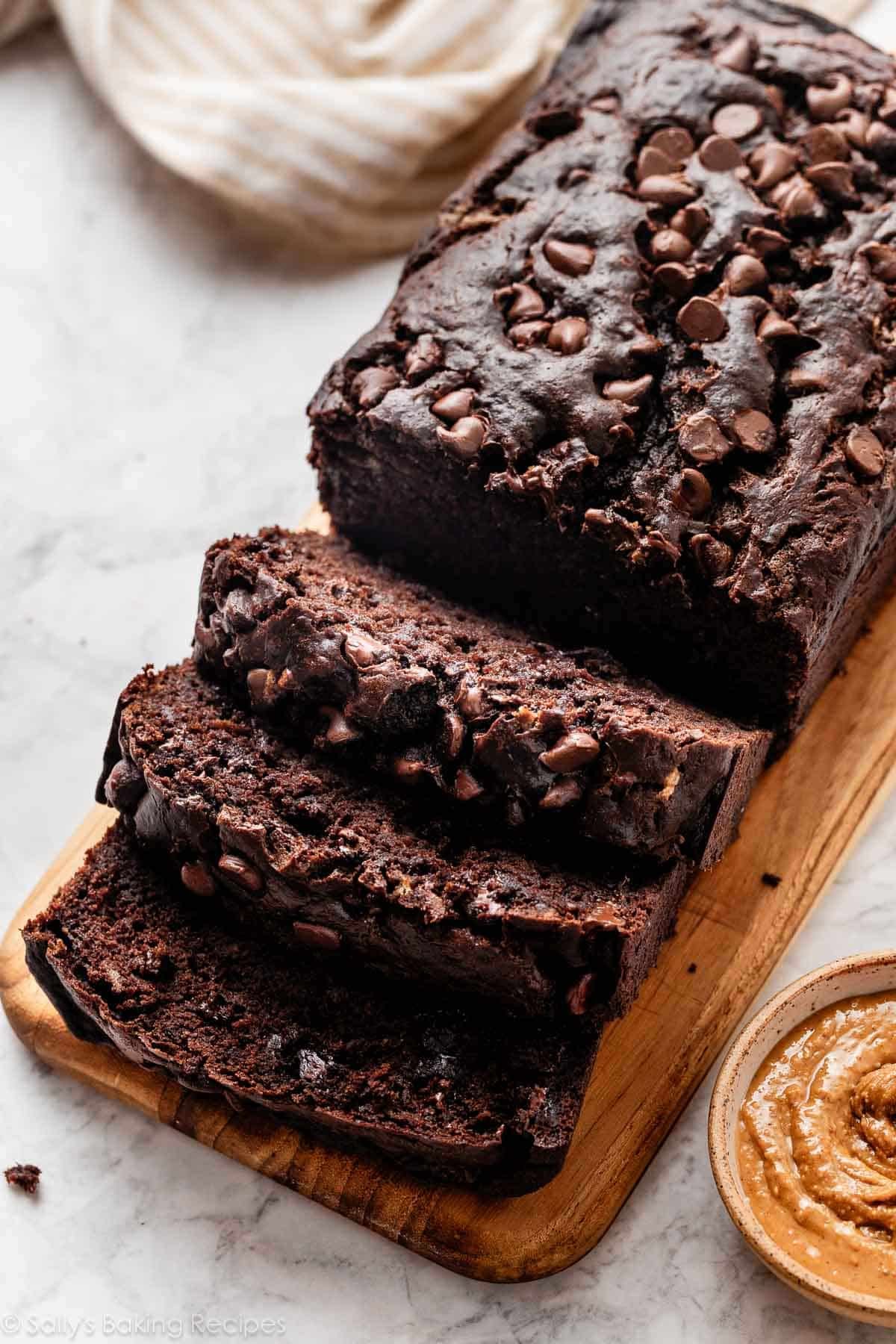 chocolate banana bread sliced on cutting board.