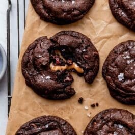 salted caramel dark chocolate cookies on brown parchment paper.