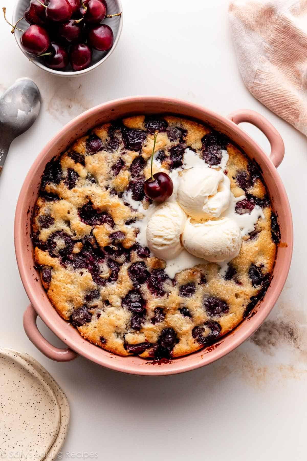 fresh cherry cobbler with vanilla ice cream on top.