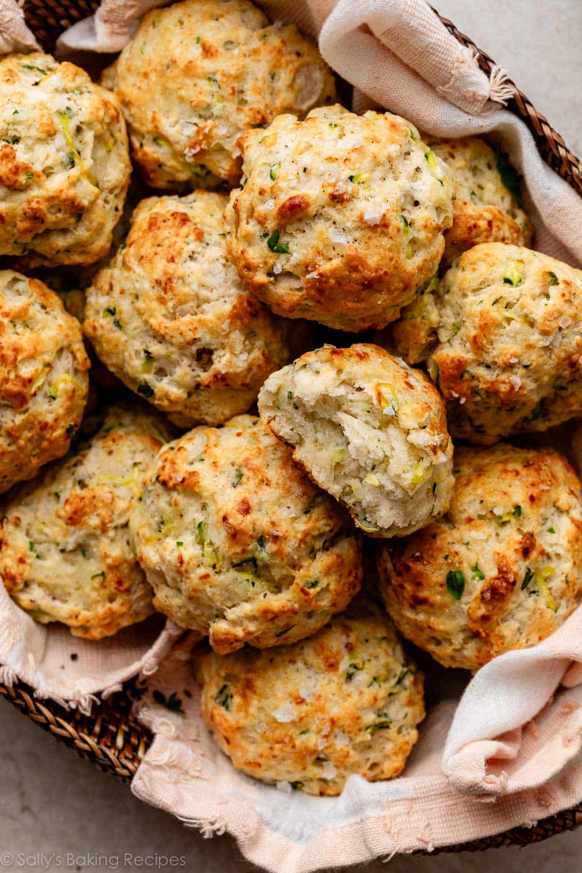 zucchini biscuits in pink linen-lined basket.