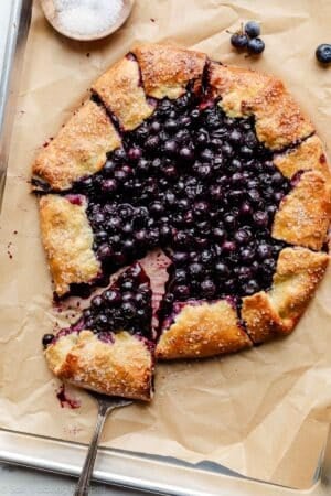 blueberry galette with slice being removed.