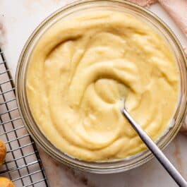 pastry cream in glass bowl with spoon.